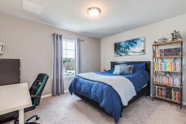 bedroom featuring baseboards, visible vents, and light colored carpet