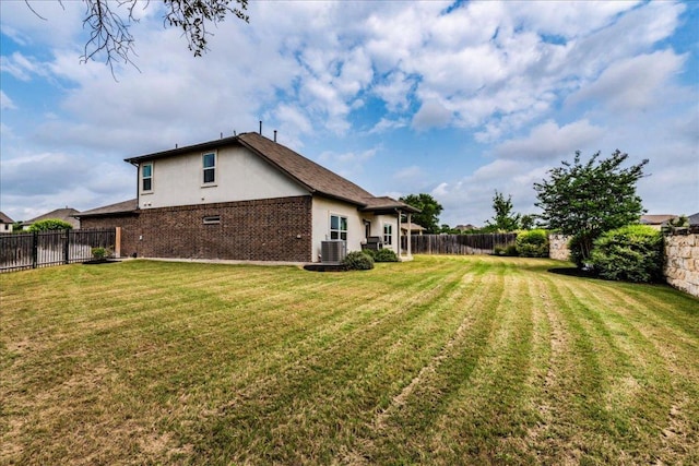 view of yard featuring central AC unit and a fenced backyard