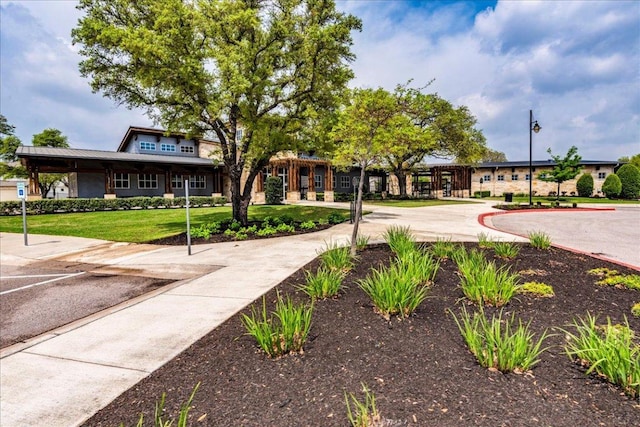 view of property's community with a lawn
