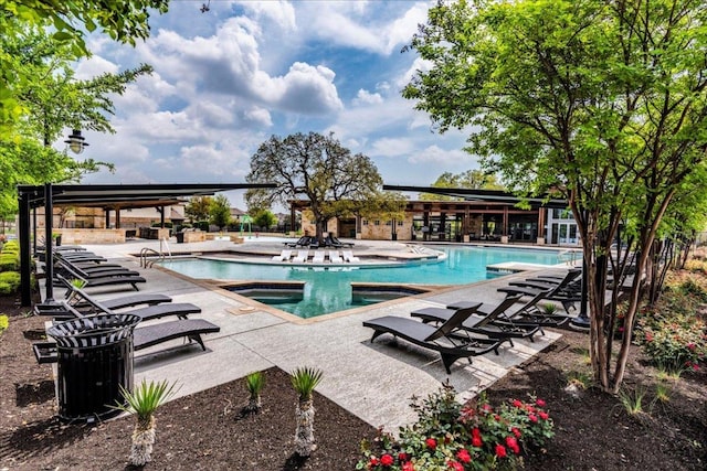 pool with a patio area and a jacuzzi