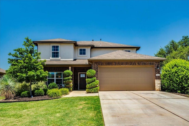 125 Groesbeck Ln, Leander, TX 78641 - view of front of house with an attached garage, driveway, stucco siding, and a front lawn