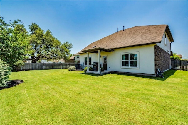 125 Groesbeck Ln, Leander, TX 78641 - rear view of house with stucco siding, central AC, roof with shingles, and a patio