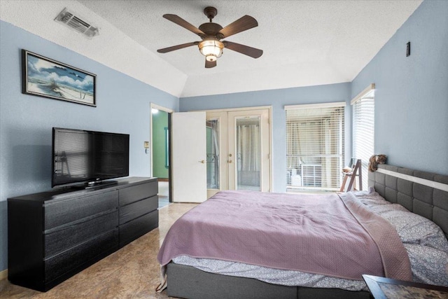 bedroom with a textured ceiling, visible vents, ceiling fan, vaulted ceiling, and french doors