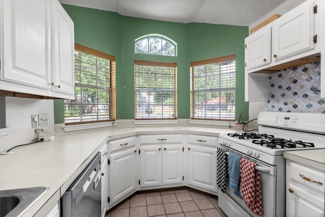 kitchen featuring white gas range, dishwasher, white cabinetry, and light countertops