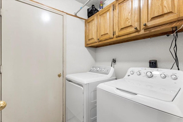 laundry area featuring cabinet space and washer and clothes dryer