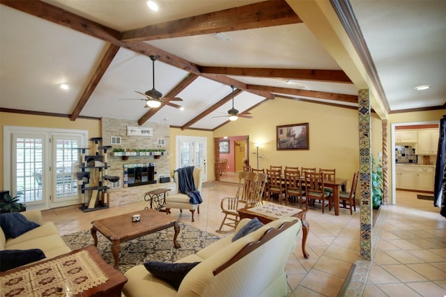 living room featuring a wealth of natural light, a ceiling fan, and light tile patterned flooring