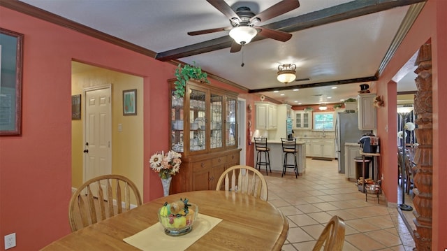 dining space with ornamental molding, ceiling fan, and light tile patterned floors
