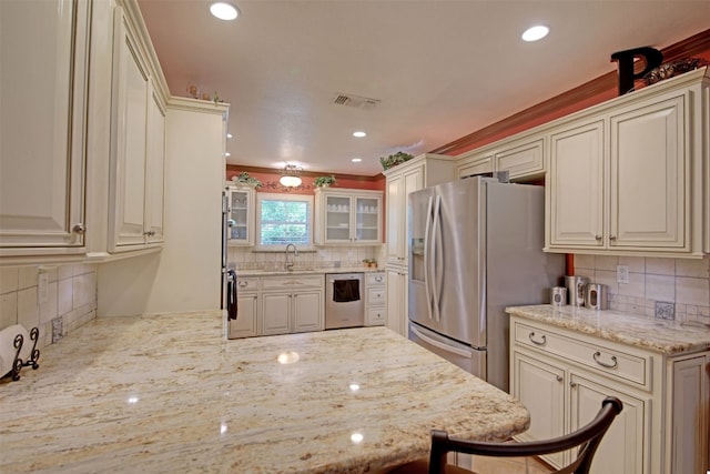 3005 Crystal Cir, Taylor, TX 76574 - kitchen with a sink, appliances with stainless steel finishes, backsplash, light stone countertops, and recessed lighting