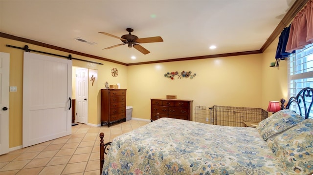 bedroom with light tile patterned floors, crown molding, visible vents, and a barn door