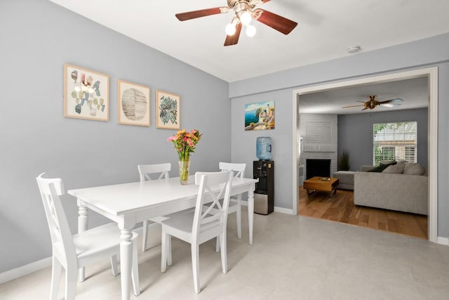 1904 Goodrich Ave Unit 16, Austin, TX 78704 - dining room featuring ceiling fan, a brick fireplace, and baseboards