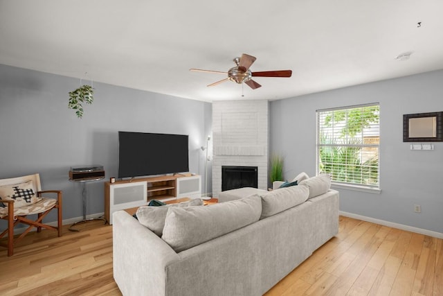1904 Goodrich Ave Unit 16, Austin, TX 78704 - living area featuring ceiling fan, baseboards, light wood-style floors, and a fireplace
