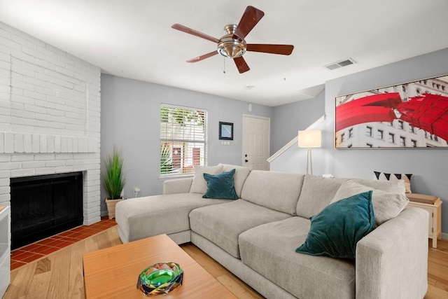 1904 Goodrich Ave Unit 16, Austin, TX 78704 - living room featuring wood finished floors, a ceiling fan, and a brick fireplace