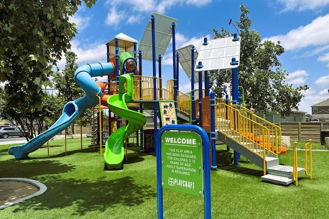 communal playground featuring fence and a yard