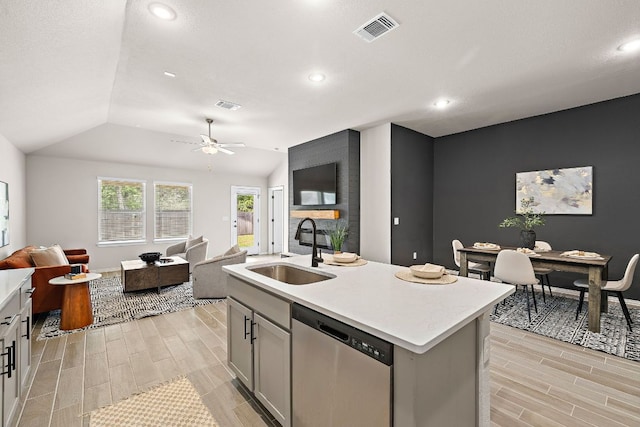 135 Hackberry Ln, Bastrop, TX 78602 - kitchen featuring dishwasher, a sink, visible vents, wood tiled floor, and open floor plan