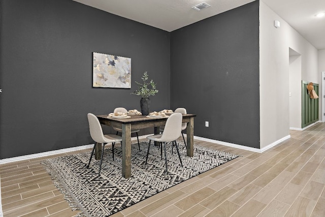135 Hackberry Ln, Bastrop, TX 78602 - dining area featuring visible vents, wood finished floors, and baseboards