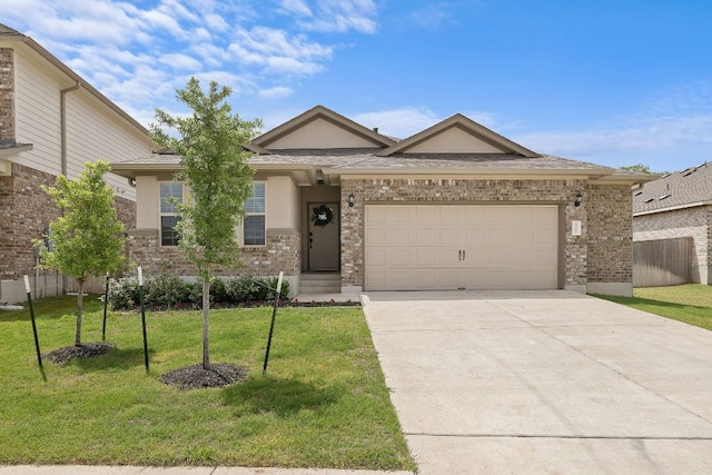 135 Hackberry Ln, Bastrop, TX 78602 - view of front facade with driveway, a garage, brick siding, and stucco siding