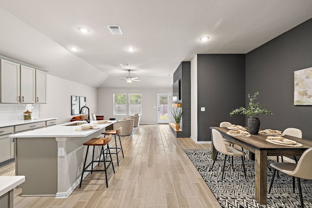 135 Hackberry Ln, Bastrop, TX 78602 - kitchen featuring a sink, ceiling fan, light wood-style floors, light countertops, and recessed lighting