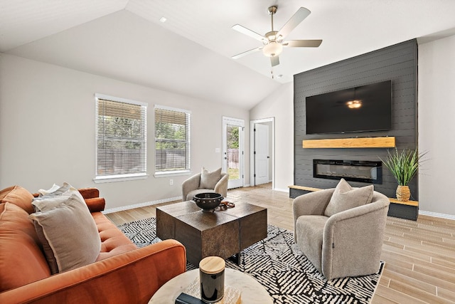 135 Hackberry Ln, Bastrop, TX 78602 - living area with ceiling fan, light wood-style floors, baseboards, vaulted ceiling, and a fireplace