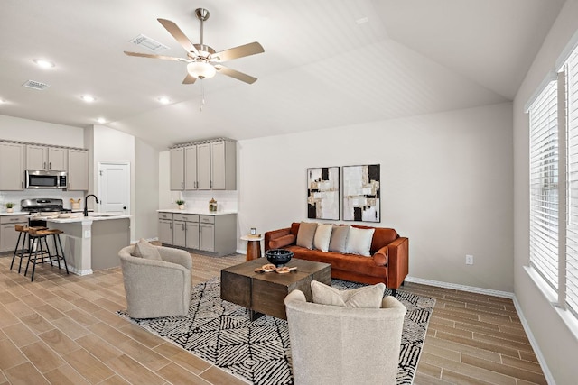 135 Hackberry Ln, Bastrop, TX 78602 - living area with vaulted ceiling, a ceiling fan, light wood finished floors, baseboards, and recessed lighting