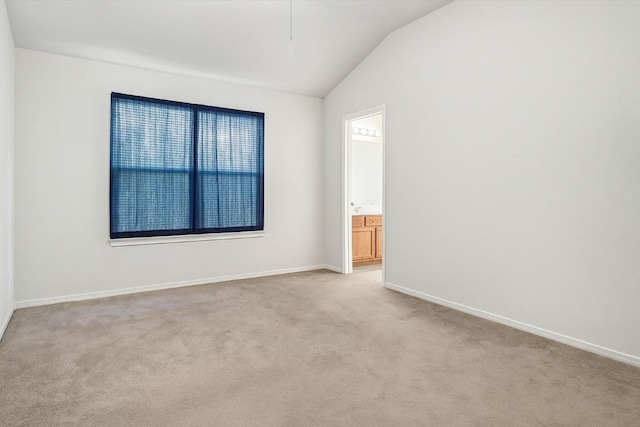 1516 Gunnison Cv, Lockhart, TX 78644 - spare room featuring vaulted ceiling, light carpet, and baseboards