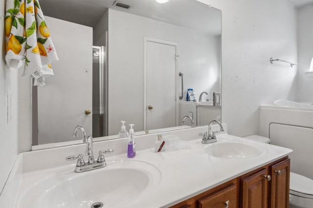 1516 Gunnison Cv, Lockhart, TX 78644 - bathroom featuring toilet and double vanity