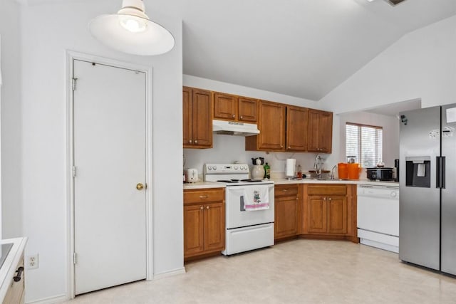 1516 Gunnison Cv, Lockhart, TX 78644 - kitchen with white appliances, under cabinet range hood, lofted ceiling, light countertops, and light floors