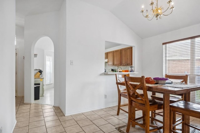 1516 Gunnison Cv, Lockhart, TX 78644 - dining area with arched walkways, a chandelier, high vaulted ceiling, light tile patterned floors, and baseboards