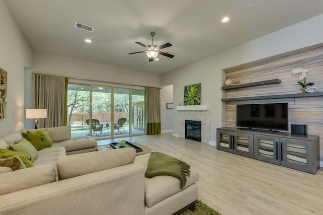2724 Rain Song Dr, Leander, TX 78641 - living area featuring a ceiling fan, wood finished floors, a fireplace, and recessed lighting