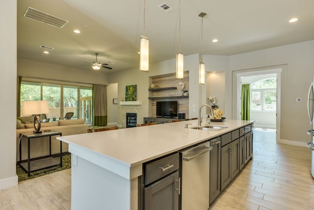 2724 Rain Song Dr, Leander, TX 78641 - kitchen featuring stainless steel dishwasher, light wood-style floors, plenty of natural light, and recessed lighting