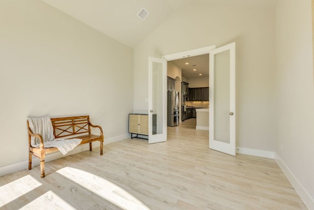2724 Rain Song Dr, Leander, TX 78641 - living area with light wood-style floors, lofted ceiling, and french doors