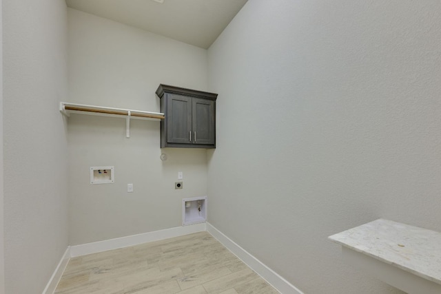 2724 Rain Song Dr, Leander, TX 78641 - washroom with electric dryer hookup, washer hookup, light wood-style floors, cabinet space, and hookup for a gas dryer