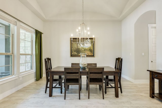 2724 Rain Song Dr, Leander, TX 78641 - dining space featuring lofted ceiling, arched walkways, light wood-type flooring, a chandelier, and plenty of natural light