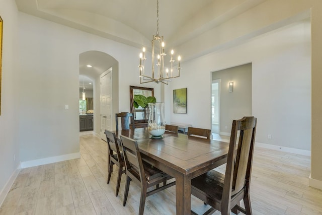 2724 Rain Song Dr, Leander, TX 78641 - dining space featuring arched walkways, light wood-style floors, a chandelier, vaulted ceiling, and recessed lighting