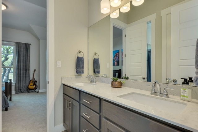2724 Rain Song Dr, Leander, TX 78641 - bathroom featuring double vanity and lofted ceiling