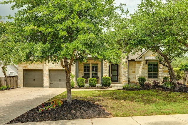 2724 Rain Song Dr, Leander, TX 78641 - obstructed view of property with stone siding, concrete driveway, and an attached garage