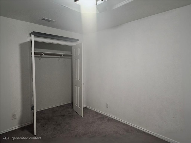 unfurnished bedroom featuring a closet, visible vents, and carpet