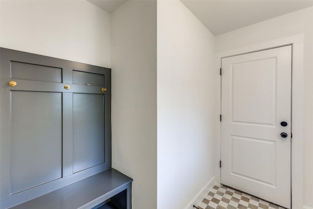 mudroom featuring light floors and baseboards