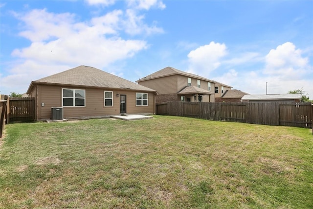 back of property featuring a fenced backyard, central air condition unit, a yard, and a patio area