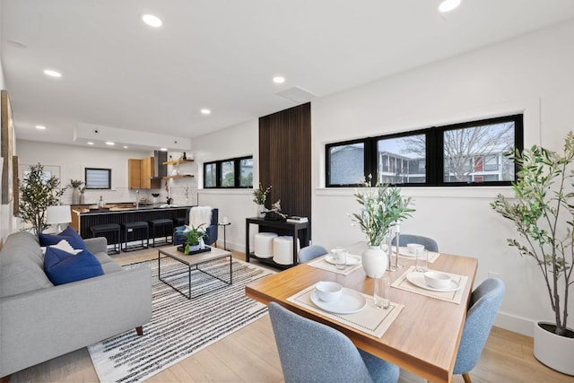 living room with recessed lighting, light wood-style floors, and baseboards