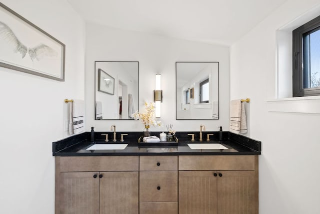full bath with a sink and double vanity