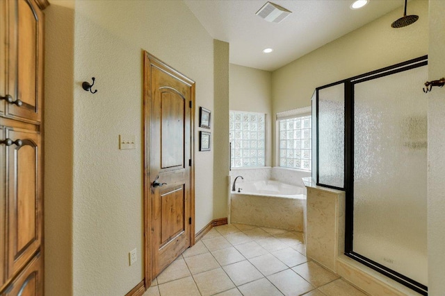 bathroom with a garden tub, a stall shower, visible vents, and tile patterned floors