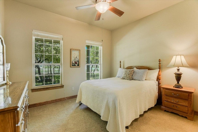bedroom featuring ceiling fan, baseboards, and light carpet