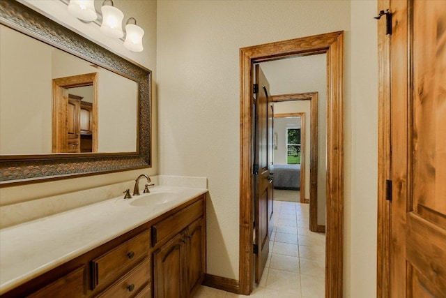 ensuite bathroom with tile patterned floors, ensuite bathroom, and vanity