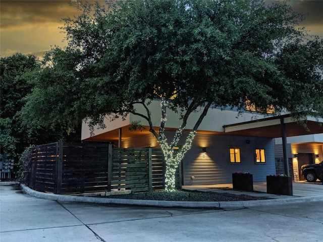 contemporary home featuring fence