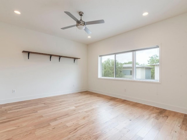 spare room with baseboards, recessed lighting, and light wood-style flooring