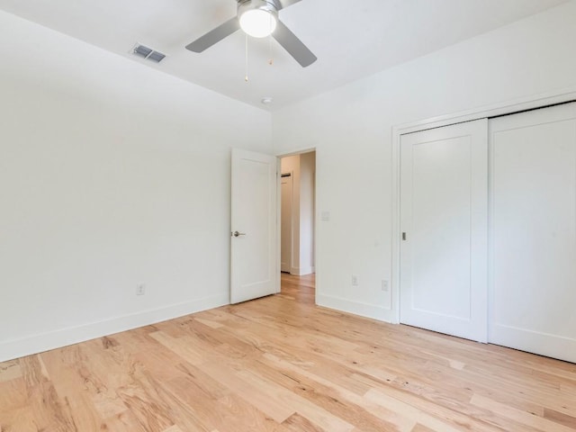 unfurnished bedroom with baseboards, visible vents, a closet, and light wood-style flooring