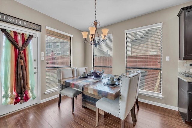 3306 Castleton Dr, Killeen, TX 76542 - dining room featuring a notable chandelier, dark wood-style flooring, and baseboards