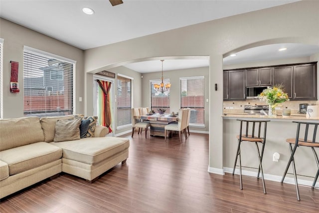 3306 Castleton Dr, Killeen, TX 76542 - living area with baseboards, recessed lighting, arched walkways, a chandelier, and dark wood-style floors