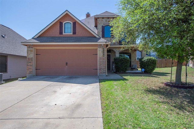 3306 Castleton Dr, Killeen, TX 76542 - traditional-style house with concrete driveway, stone siding, a front yard, fence, and central AC