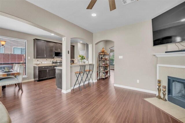 3306 Castleton Dr, Killeen, TX 76542 - kitchen featuring dark brown cabinetry, stainless steel appliances, light countertops, ceiling fan, and a kitchen bar